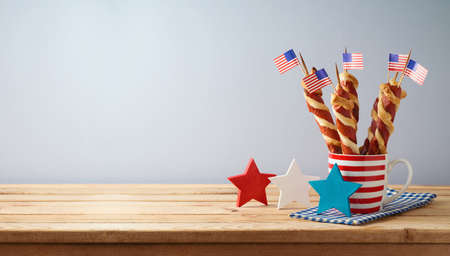 Happy Independence Day, 4th of July celebration concept with twisted hot dog sausages and USA flag...