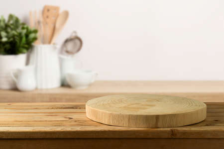 Empty wooden log on rustic table over kitchen shelf background.  Interior mock up for design and...