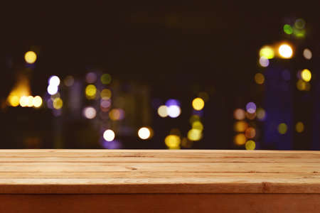 Empty wooden table over abstract blurred restaurant lights background.  Mock up for design and product display.の写真素材