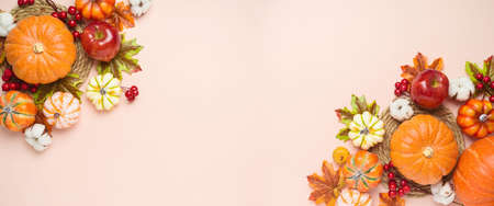 Thanksgiving holiday background with pumpkin, apples and fall leaves. Autumn season banner with copy spaceの写真素材