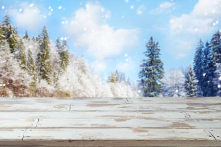 Empty wooden table over winter landscape background.  Christmas and New Year mock up for design and product display.の写真素材