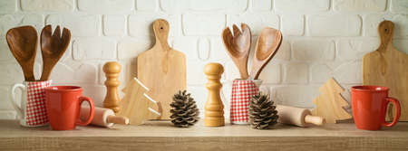 iKichen utensils and coffee cup on wooden shelf. Christmas and New Year holiday mock up for designの写真素材