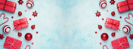 Christmas holiday banner with gift boxes and decorations. New Year greeting card  mock up background. Top view with copy spaceの写真素材