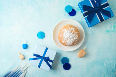 Flat lay composition for jewish holiday Hanukkah with traditional donuts and gift box