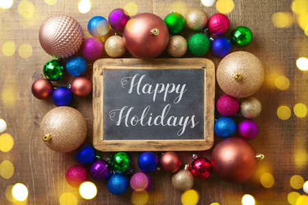 Happy Holidays greeting background with trendy modern balls ornament. Top view with copy spaceの写真素材