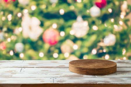 Empty wooden log  on rustic table over Christmas tree festive bokeh background.  Christmas and New...