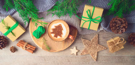 Hygge Scandinavian style concept with coffee cup and eco friendly decorations on wooden background. Cozy winter Christmas top view compositionの写真素材