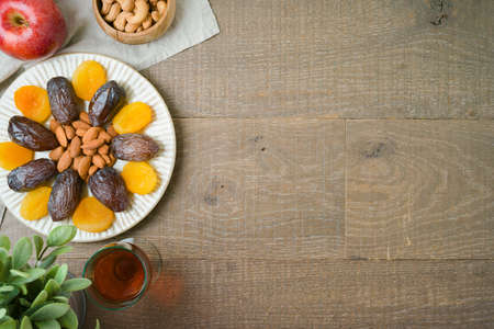 Flat lay composition for Jewish holiday Tu Bishvat with dried druits, wine and nuts. Top view with copy spaceの写真素材
