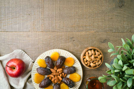 Dried dates, fruits and nuts for Jewish holiday Tu Bishvat celebration. Top view background.の写真素材