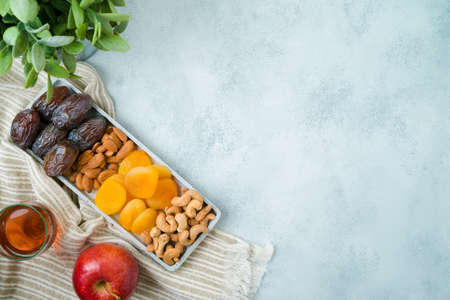 Jewish holiday Tu Bishvat modern background with dried dates, fruits and nuts. Top view with copy spaceの写真素材