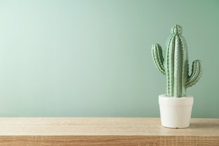 Empty wooden shelf with cactus over green background. Kitchen mock up for designの写真素材