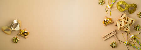 Jewish holiday Purim banner background with carnival mask and hamantaschen cookies. Top view, flat lay  with copy spaceの写真素材