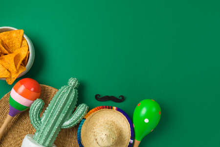 Cinco de Mayo holiday background with Mexican cactus, nachos chips, maracas and party sombrero hat. Top view, flat layの写真素材