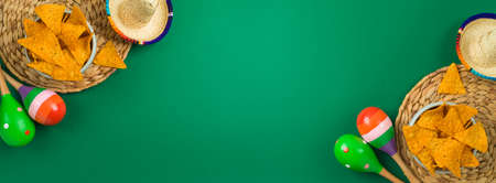 Cinco de Mayo holiday background with Mexican Nachos chips, maracas and party sombrero hat. Top view, flat layの写真素材