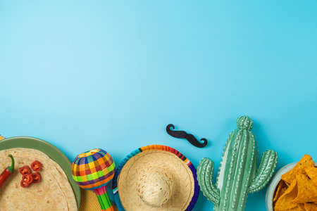 Cinco de Mayo holiday background with Mexican cactus, nachos chips, maracas and party sombrero hat. Top view, flat layの写真素材
