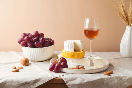 Cheese, grapes, nuts and wine on table. Shavuot festive celebration concept