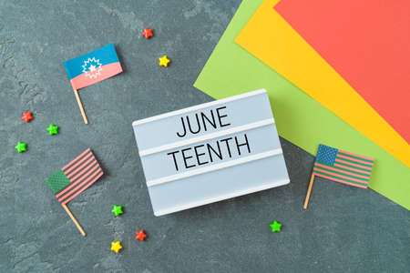 Juneteenth African American holiday concept with text and flags on dark backgroundの写真素材