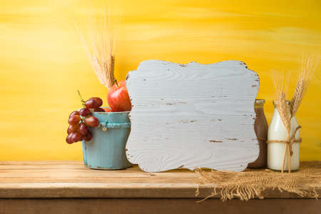 Wooden board, milk bottle and fruits on table background. Jewish holiday shavuot conceptの写真素材