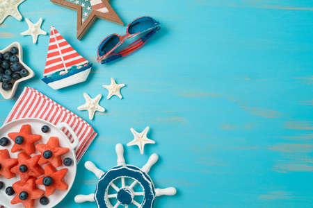 Summer beach party for Happy Independence Day, 4th of July. Fruit salad with watermelon and blueberries on wooden background. Top view, flat layの写真素材
