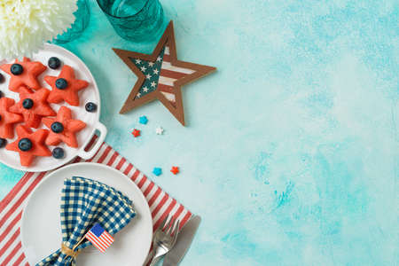 4th of July festive table setting  with summer fruit salad, plate and decorations. Happy Independence Day party background. Top view, flat layの写真素材