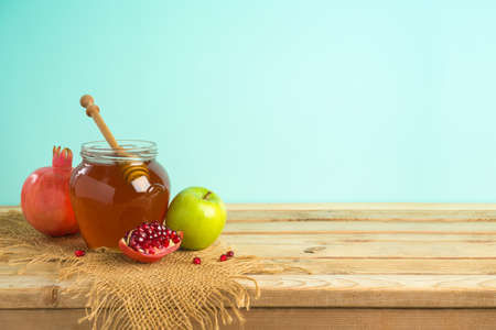Jewish holiday Rosh Hashana background with honey, apple and pomegranate on wooden tableの写真素材