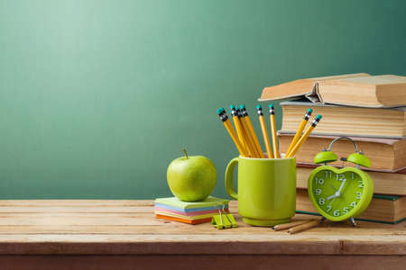 Student desk with books, apple and pencils. Back to school backgroundの写真素材
