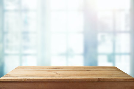 Empty wooden  table over window blurred  background. Kitchen interior mock up for design and product displayの写真素材