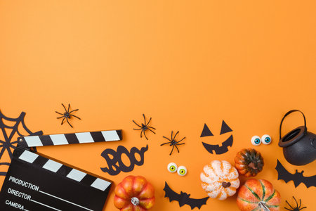 Halloween party concept . Horror movie night background  with   pumpkin, decorations and movie clapperboard. Top view, flat layの写真素材