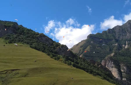 Paragliders in the Caucasus mountains