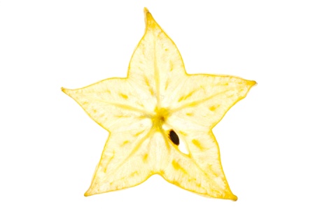 A thinly sliced section of star fruit lit from behindの写真素材