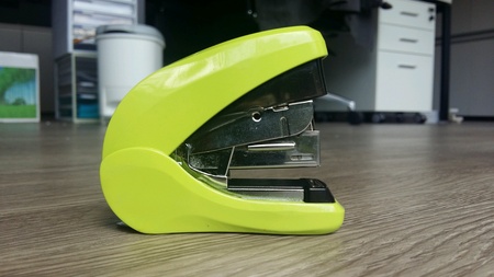 Green stapler on parquetの素材