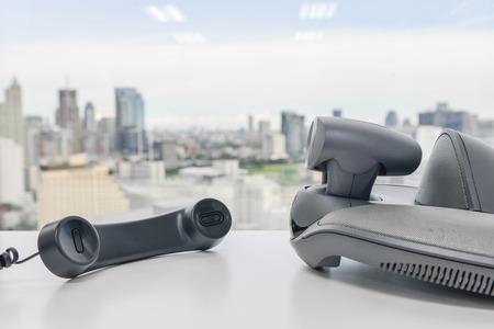 Video Conference Device and Phone handset on the white tableの写真素材