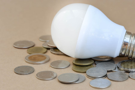 Concept of LED bulb with coins - the choice of saving technologyの写真素材