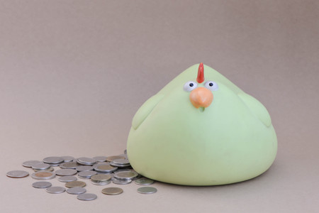 Chicken piggy bank and a lot of coins - money savingの写真素材