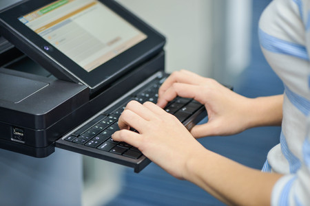 Business woman is using the printer to scanning and printing documentの写真素材