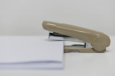 Stapling the paper with staplerの写真素材