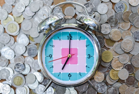 Clock with 7 AM on the coins stackの写真素材