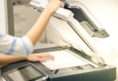 Business woman is using the printer to scanning the documentの写真素材
