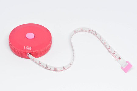 Pink measuring tape on the white backgroundの写真素材