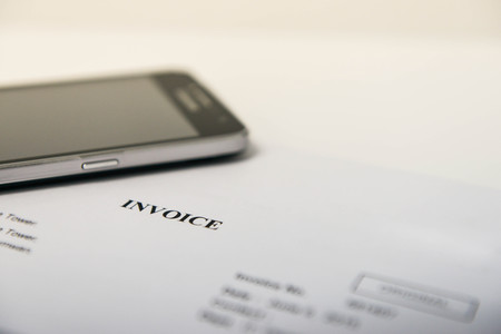 Invoice and mobile phone for concept of mobile paymentの写真素材