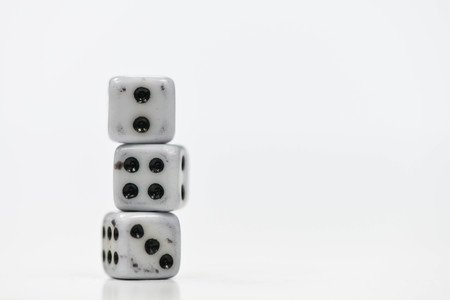 Old three dice stack on the white screenの写真素材