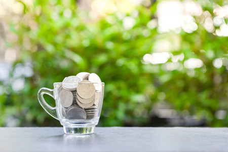 Coins in the glass - concept of saving moneyの写真素材