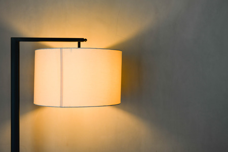 Lamp with lighting on the concrete wall backgroundの写真素材