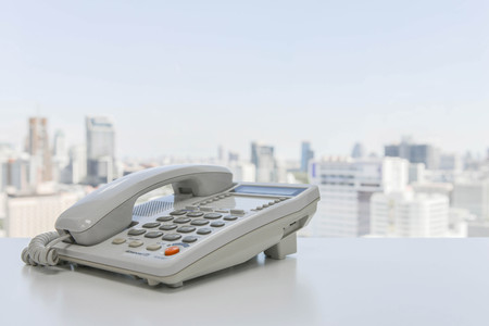 White office phone on the white tableの写真素材