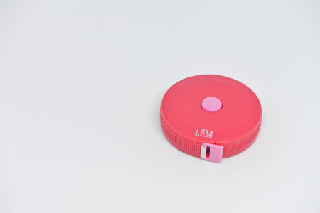 Pink measuring tape on the white backgroundの写真素材