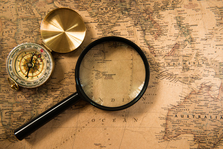 Compass and Magnifying glass on the vintage map for traveling conceptの写真素材