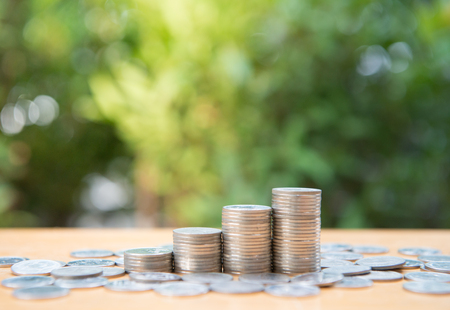 Growing coin stack with nature background for saving money concept