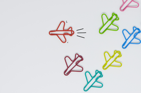 Business concept for group of plane paperclip point to one direction with another one red individual...