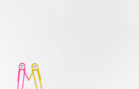 business concept for paper clip as the human shake hand on the white backgroundの写真素材