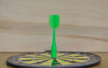 Close up green darts arrow on the target center of dartboar for business goal conceptの写真素材